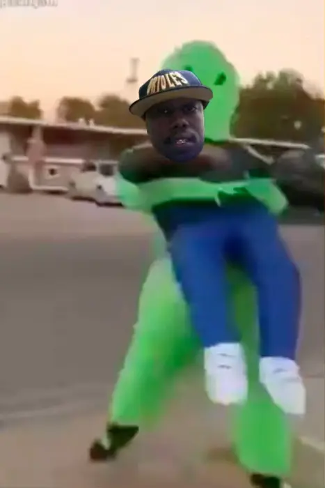 A guy in green alien suit holds a man meme | image tagged in memes | made with Piñata Farms meme generator